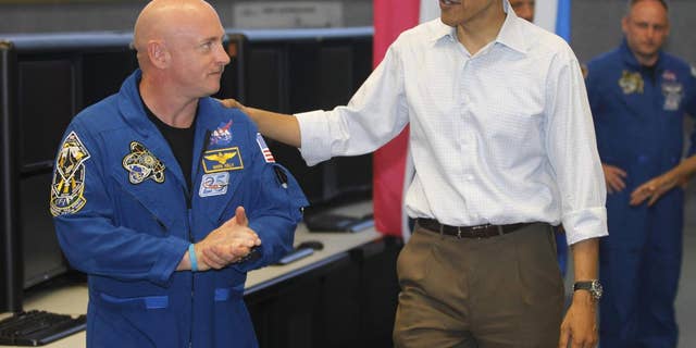 President Barack Obama meets with Space Shuttle Endeavor commander Mark Kelly, husband of wounded Rep. Gabrielle Giffords, D-Ariz., and shuttle astronauts, after their launch was scrubbed, Friday, April 29, 2011, at Kennedy Space Center in Cape Canaveral, Fla. (AP Photo/Charles Dharapak)