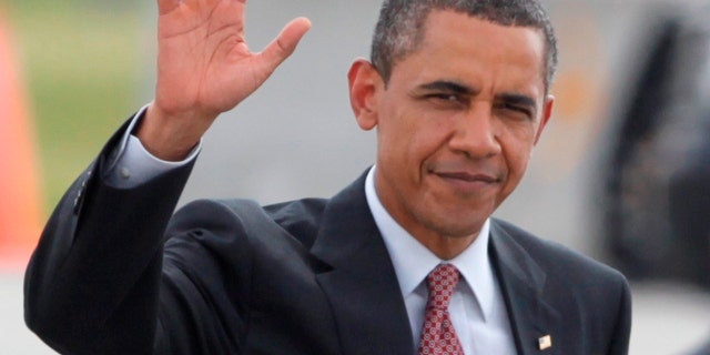 President Barack Obama waves as he walks across the tarmac to board Air Force One Thursday, June 23, 2011, in Fort Drum, N.Y., en route to New York City. (AP Photo/Carolyn Kaster)