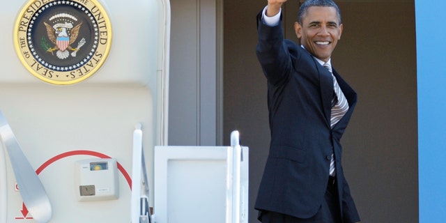 President Obama waves as he boards Air Force One at Andrews Air Force Base, Md., Wednesday, Sept. 14, 2011.