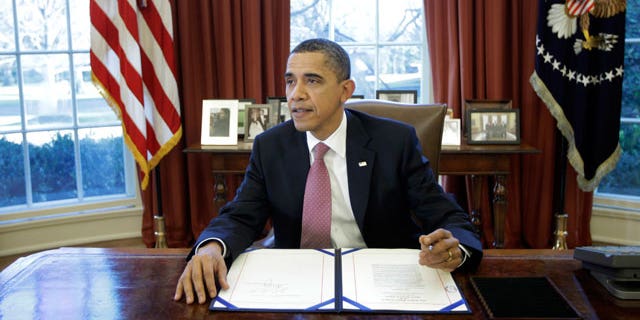 President Obama signs the two-week funding bill averting a government shutdown in the Oval Office at the White House in Washington, Wednesday, March 2, 2011. (AP)