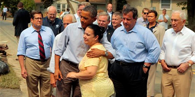 President Obama hugs a woman on a flood damaged street in Wayne, N.J., as he visits areas damaged by Hurricane Irene Sept. 4. At right is New Jersey Gov. Chris Christie.