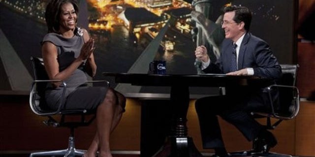 April 11, 2012: In this photo provided by Comedy Central, first lady Michelle Obama laughs with Stephen Colbert during her appearance on The Colbert Report.