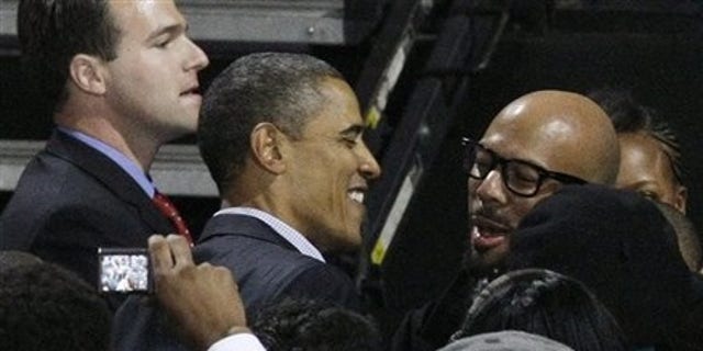 President Barack Obama, left, hugs rapper Common after a Moving America Forward rally for Democratic candidates Saturday, Oct. 30, 2010 in Chicago.(AP)