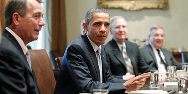 President Obama sits with House Speaker John Boehner, Senate Minority Leader Mitch McConnell and Sen. Dick Durbin as he meets regarding the debt ceiling in the Cabinet Room of the White House July 13.