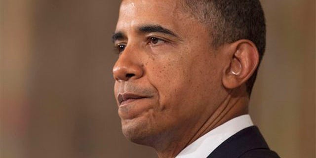 Monday: President Obama pauses as he speaks in the State Dining Room of the White House on the Standard & Poor's downgrade of U.S. credit risk.