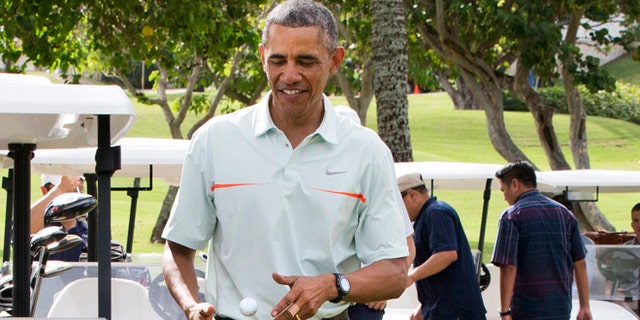 Dec. 24, 2014: President Obama  tosses a golf ball between his hands after finishing the 18th hole at Marine Corps Base Hawaii's Kaneohe Klipper Golf Course in Kaneohe, Hawaii.