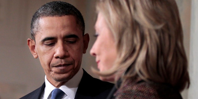 Wednesday: President Obama and Secretary of State Hillary Clinton walk away from the podium after delivering a statement on Libya in the Grand Foyer of the White House in Washington.