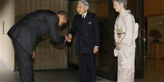 The president bows as he is greeted by Japanese Emperor Akihito and Empress Michiko as he arrives at the Imperial Palace in Tokyo (AP Photo)