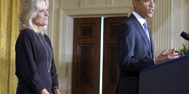 President Barack Obama speaks at the Community College Summit as Dr. Jill Biden, left, listens in the East Room of the White House in Washington, Tuesday, Oct. 5, 2010. (AP Photo/Susan Walsh)