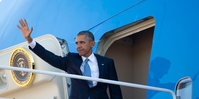 Friday, Oct. 9, 2015: President Obama waves as he boards Air Force One before his departure from Andrews Air Force Base, Md. Obama is traveling to Roseburg, Ore., to meet with families of the victims of the Oct. 1, shooting at Umpqua Community College, as part of a four-day West Coast tour.