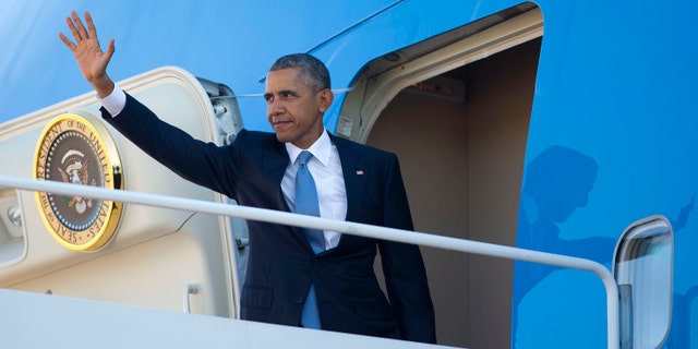 Friday, Oct. 9, 2015: President Obama waves as he boards Air Force One before his departure from Andrews Air Force Base, Md. Obama is traveling to Roseburg, Ore., to meet with families of the victims of the Oct. 1, shooting at Umpqua Community College, as part of a four-day West Coast tour.