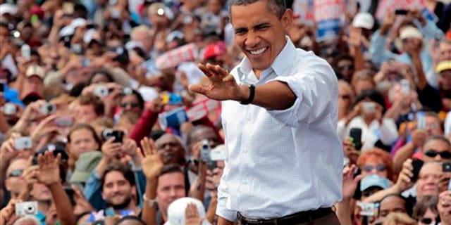 Sept. 5: President Barack Obama waves to supporters during a Labor Day speech at Detroit's Renaissance Center, headquarters of General Motors, in Detroit, Mich.