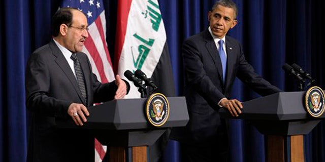 Dec. 12, 2011: President Obama listens as Iraq's Prime Minister Nouri al-Maliki speaks during a news conference at the White House in Washington.