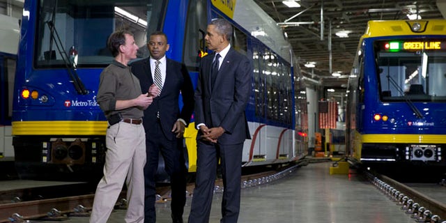 Feb. 26, 2014: Mark Fuhrmann, New Start Program Director of Metro Transit, left, talks with President Obama and Transportation Secretary Anthony Foxx, during a tour of the Metro Transit Light Rail Operations and Maintenance Facility in St. Paul, Minn.