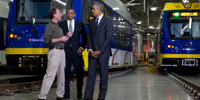 Feb. 26, 2014: Mark Fuhrmann, New Start Program Director of Metro Transit, left, talks with President Obama and Transportation Secretary Anthony Foxx, during a tour of the Metro Transit Light Rail Operations and Maintenance Facility in St. Paul, Minn.