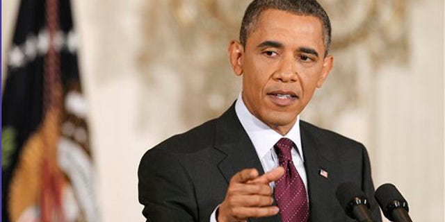 President Obama gestures during a news conference in the East Room of the White House in Washington June 29.