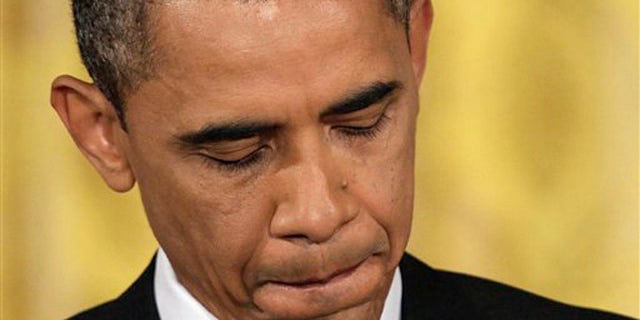 President Obama pauses before answering a question during a news conference in the East Room of the White House June 29.