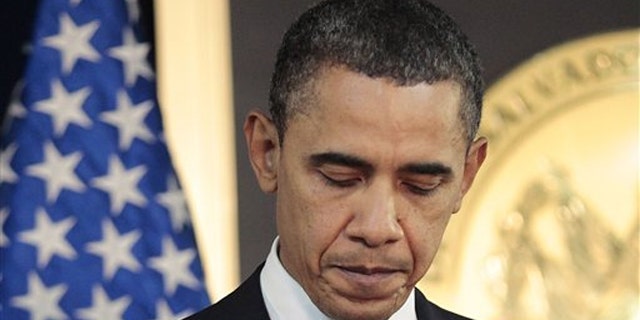 President Obama pauses after answering questions on the ongoing situation in Libya during a news conference in San Salvador, El Salvador, March 22.