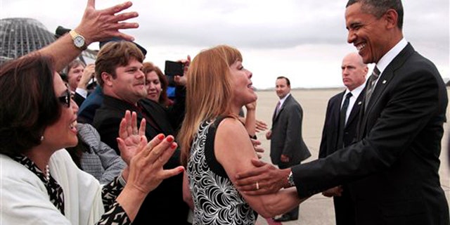 President Obama stops to greet people on the tarmac during his arrival at Moffett Airfield, near San Jose, Calif., Sept. 25.