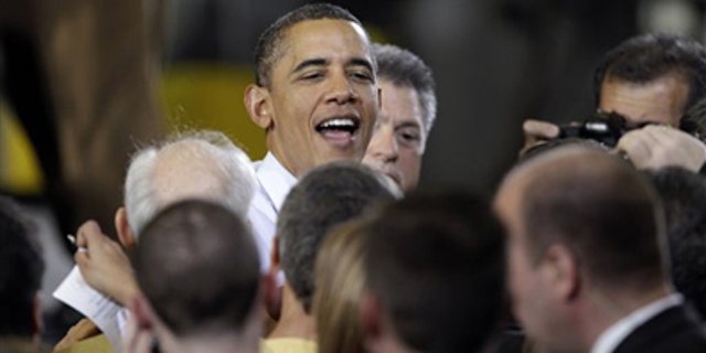 Jan. 25, 2012: President Obama is greeted after speaking about manufacturing jobs, at the Conveyor Engineering & Manufacturing plant, in Cedar Rapids, Iowa.