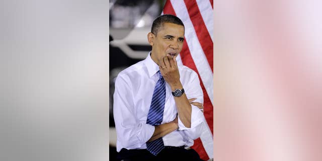 President Barack Obama listens as Vice President Joe Biden speaks at the Chrysler Indiana Transmission Plant II in Kokomo, Ind., Tuesday, Nov. 23, 2010. (AP Photo/Darron Cummings)