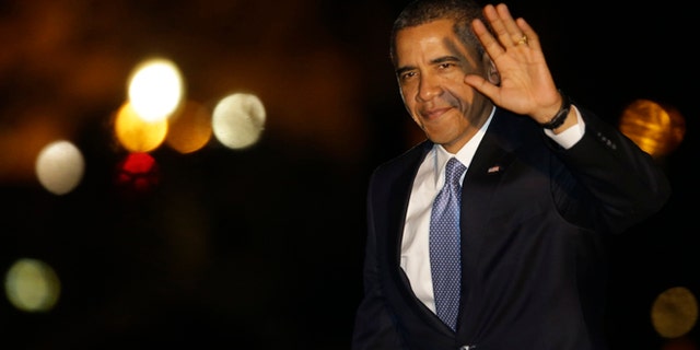 Jan. 29, 2013: President Obama waves to reporters as he walks on the South Lawn of the White House in Washington.