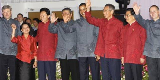 President Obama poses with other APEC leaders for their official group photo during the Gala Dinner at the APEC Summit in Singapore. (AP Photo)