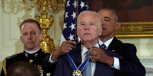 President Barack Obama presents Vice President Joe Biden with the Presidential Freedom Medal at a ceremony in the Washington White House Dining Room on Thursday, January 12, 2017. (AP Photo / Susan Walsh)