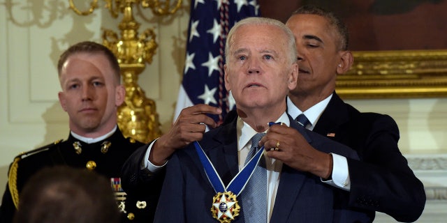 President Barack Obama presents Vice President Joe Biden with the Presidential Freedom Medal at a ceremony in the Washington White House Dining Room on Thursday, January 12, 2017. (AP Photo / Susan Walsh)