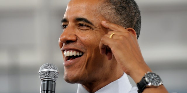 President Barack Obama responds to a question from a member of the audience during a campaign event.
