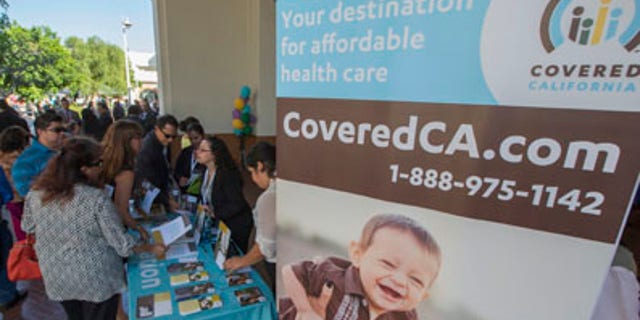 People sign up for health insurance information at a Covered California event which marks the opening of the state's Affordable Healthcare Act, commonly known as Obamacare, health insurance marketplace in Los Angeles, California, October 1, 2013. Technical glitches and heavy internet traffic slowed Tuesday's launch of new online insurance exchanges at the heart of President Barack Obama's healthcare reform, showcasing the challenge of covering millions of uninsured Americans. REUTERS/Lucy Nicholson (UNITED STATES - Tags: POLITICS HEALTH) - RTR3FI11