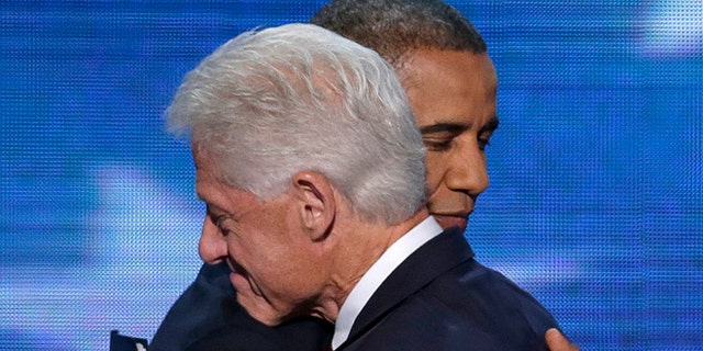 Sept. 5, 2012: Former President Bill Clinton hugs President Barack Obama after President Obama walked on stage after Clinton's speech the Democratic National Convention in Charlotte, N.C.