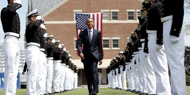 President Obama walks through an honor cordon as he arrives for the 134th Commencement Exercises of the United States Coast Guard Academy in New London, Ct.