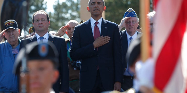 June 6, 2014: U.S. President Barack Obama, centre and French President Francois Hollande stand, during the playing of the Star Spangled Banner, at Normandy American Cemetery at Omaha Beach as he participates in the 70th anniversary of D-Day in Colleville sur Mer, in Normandy, France. (AP)