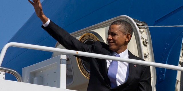 Feb. 14, 2014: President Barack Obama waves he boards Air Force One at Andrews Air Force Base, Md., en route to travel to Fresno, Calif., to discuss the ongoing drought.