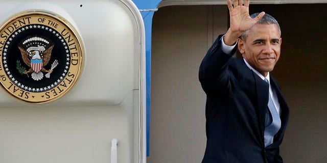 July 22, 2014: President Barack Obama waves as he prepares to depart from King County International Airport in Seattle.