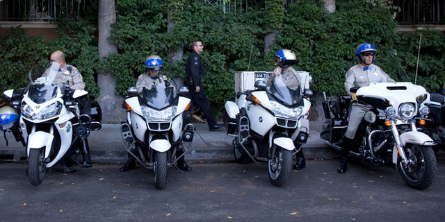 July 23, 2014: California Highway Patrol officers prepare to accompany the motorcade of President Barack Obama to a fundraising event in Los Angeles, the final city in his three-day West Coast trip to Seattle, San Francisco and Los Angeles. (AP)