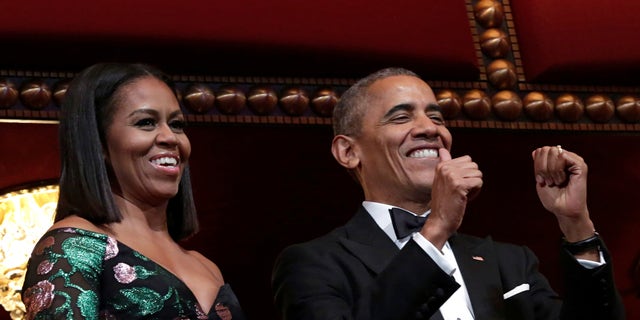 US President Barack Obama gestures as he and first lady Michelle Obama attend the Kennedy Center Honors in Washington, U.S., December 4, 2016.