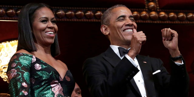 US President Barack Obama gestures as he and first lady Michelle Obama attend the Kennedy Center Honors in Washington, U.S., December 4, 2016.
