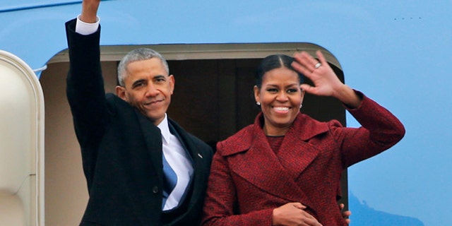 Former President Barack Obama and his wife Michelle wave to the crowd as they board an Air Force jet to depart Andrews Air Force base in Andrews Air Force Base, Md., Friday, Jan. 20, 2017. (AP Photo/Steve Helber)