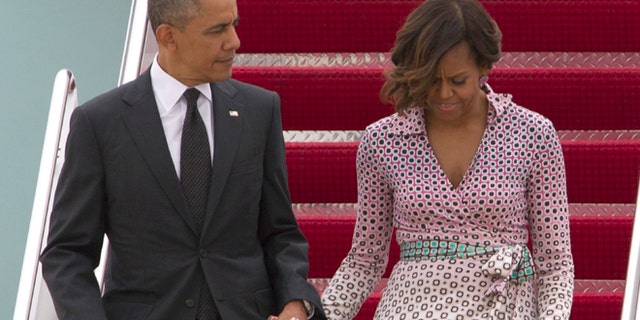 May 15, 2014: President Barack Obama and first lady Michelle Obama walk down the stairs of Air Force One upon arrival at Andrews Air Force Base, Md.