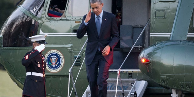 Dec. 15, 2014: President Barack Obama returns a salute as he steps off Marine One helicopter upon his return on the South Lawn of the White House in Washington. (AP)