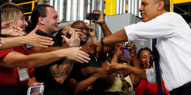 July 30, 2013: President Obama shakes hands before speaking to employees after he tours the Amazon Fulfillment Center in Chattanooga, Tennessee.