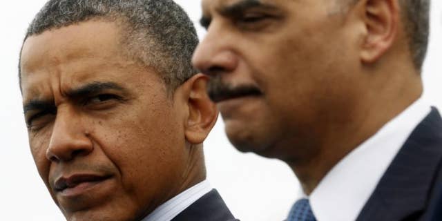 President Obama and the recently resigned Attorney General Eric Holder.