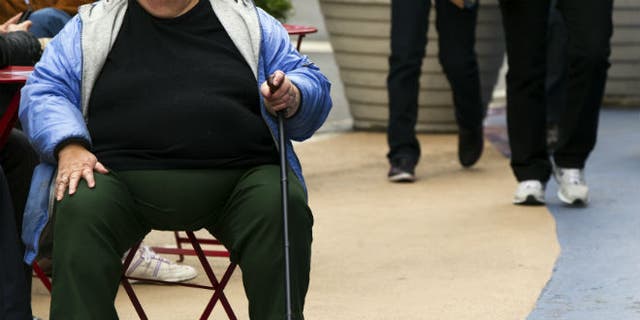 An overweight woman sits on a chair in Times Square in New York. (REUTERS/Lucas Jackson)