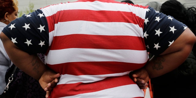FILE - This May 8, 2014 file photo shows an overweight man in New York. Being too heavy may cost you your life _ literally. Scientists say overweight people die one year earlier than expected and that moderately obese people die up to three years prematurely in the biggest-ever analysis of such data, mostly from Europe and North America. (AP Photo/Mark Lennihan, File)
