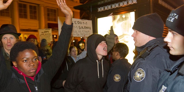 Nov. 5, 2011: A protestor yells at police after Occupy Atlanta protestors and an officer clashed as he was driving through the crowd on a motorcycle in Atlanta.