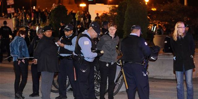 Oct. 23, 2011: Protesters are arrested during an Occupy Chicago march and protest at Grant Park in Chicago. Demonstrators of the anti-Wall Street group Occupy Chicago stood their ground in a downtown park and defied police orders to clear the area, prompting police to make more than a dozen arrests early Sunday.