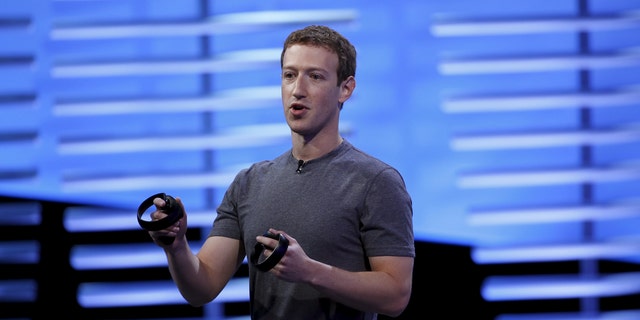 File photo - Facebook CEO Mark Zuckerberg holds a pair of the touch controllers for the Oculus Rift virtual reality headsets on stage during the Facebook F8 conference in San Francisco, California April 12, 2016. (REUTERS/Stephen Lam)