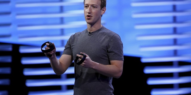 File photo - Facebook CEO Mark Zuckerberg holds a pair of the touch controllers for the Oculus Rift virtual reality headsets on stage during the Facebook F8 conference in San Francisco, California April 12, 2016. (REUTERS/Stephen Lam)